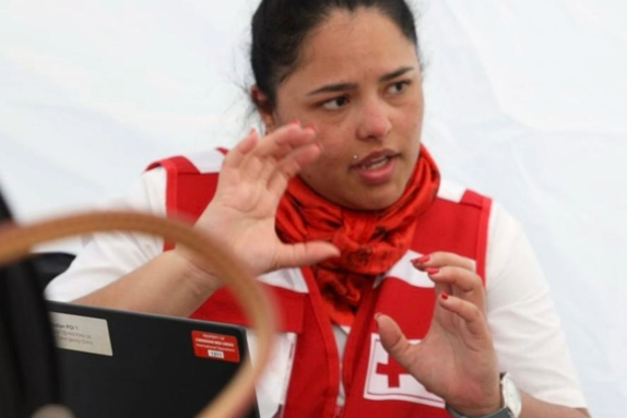 Lina Garcia, from the ICRC, is talking and moving her hands while looking away from the camera.