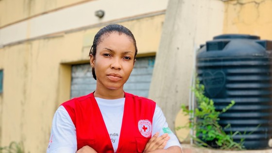 Omotoye Grace Moriyanuoluwa looking at the camera with a Red Cross jacket