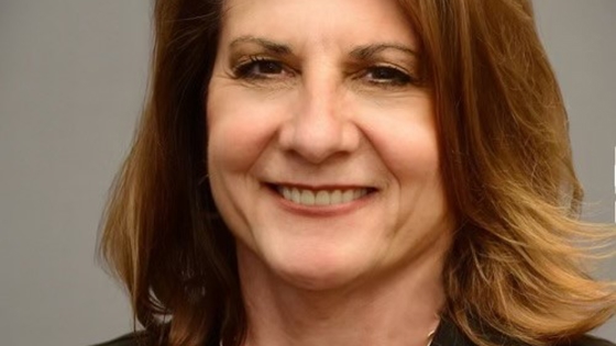 Headshot of Diane Naczi, who is smiling and looking straight at the camera.