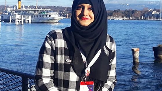 Misbah Mushtaq smiling at the camera with a port in the background