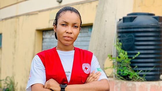 Omotoye Grace Moriyanuoluwa looking at the camera with a Red Cross jacket