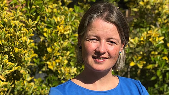 Frederike de Graaf looking at the camera with trees in the background