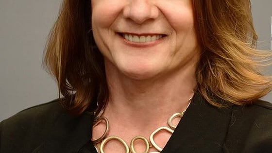 Headshot of Diane Naczi, who is smiling and looking straight at the camera.