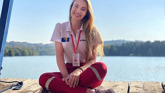 Medina Selimić sitting and looking at the camera with a lake in the background