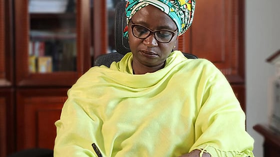Dr. Asha Mohammed sitting on her chaise working on her desk
