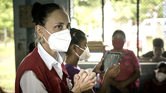 Diana Medina, IFRC, in a white face mask.