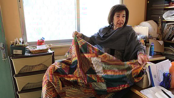 Laila Touqan Abu el Huda showing one of the handcraft work made by her students.