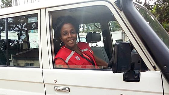 Joan Kamanga with a red jacket in a car