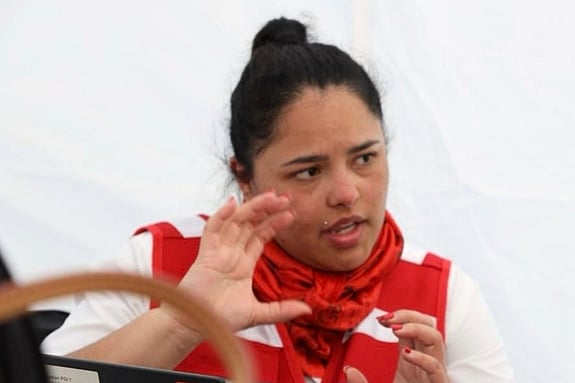 Lina Garcia, from the ICRC, is talking and moving her hands while looking away from the camera.