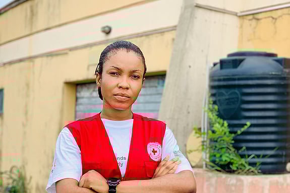 Omotoye Grace Moriyanuoluwa looking at the camera with a Red Cross jacket
