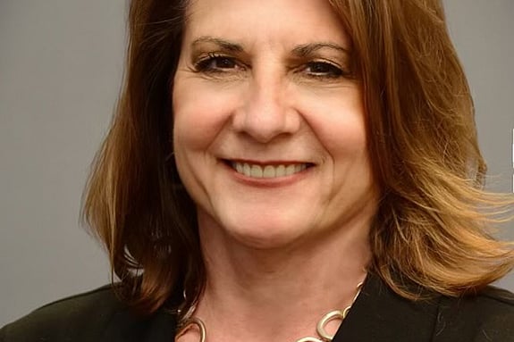 Diane Naczi's headshot, she is smiling and looking straight at the camera.